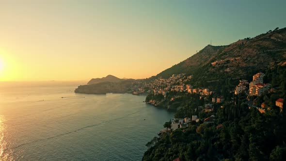 Beautiful aerial shot flying over the coast of Dubrovnik at sunset, Croatia