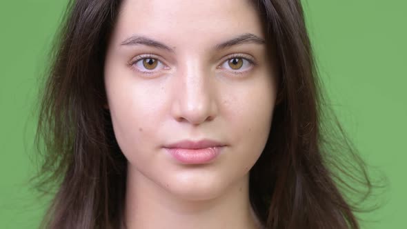 Young Beautiful Woman Against Green Background