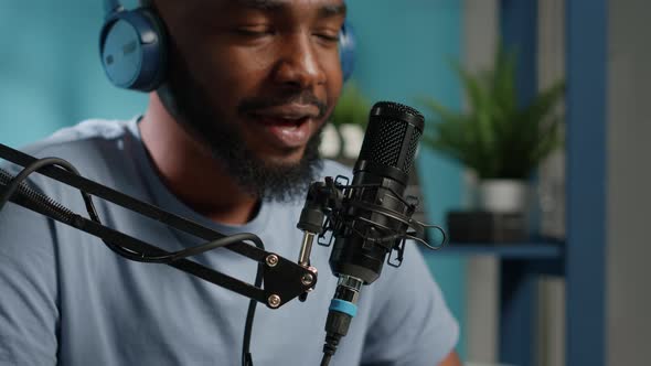 Close Up of Vlogger Using Microphone for Conversation