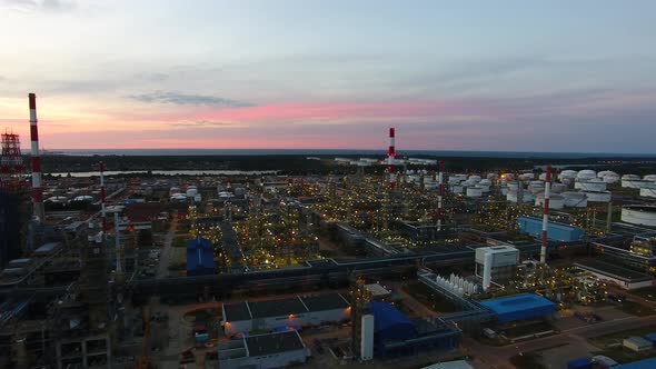 Aerial view of the petrochemical oil refinery plant shines at night