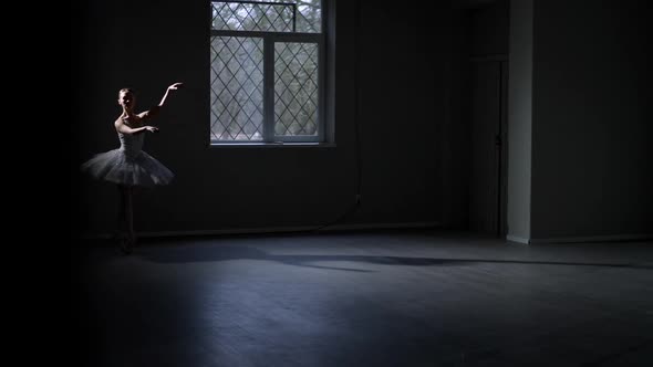 Wide Shot Slim Ballerina in White Dancing in Darkness Walking Away Leaving