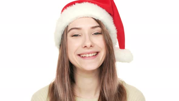 Headshot of Contented Caucasian Woman Being Happy with Christmas Holidays Wearing Santa Claus Red