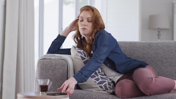 Woman lying on the couch at home