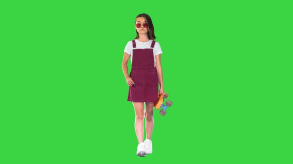 Too-cool-for-school Asian Skater Girl Walking on a Green Screen, Chroma Key