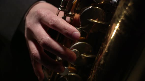 Saxophonist Plays Closeup of the Saxophone Valves with Fingers