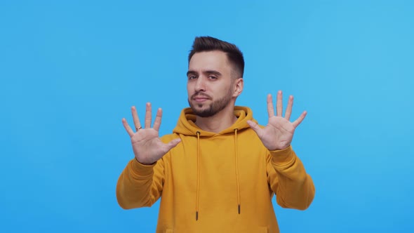 Expressive young man screaming and shouting over vibrant background.