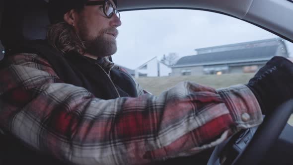 Bearded Driver In Glasses Driving Along In Truck