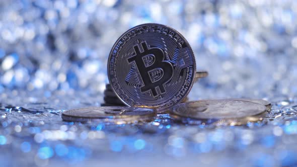 Closeup of Bitcoin Coin Shines with Multicolored Light
