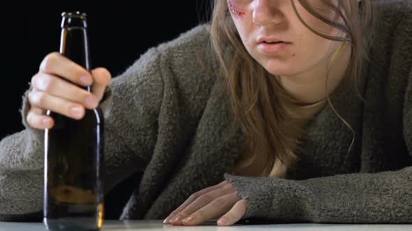 Bruised Female Drinking Alcohol to Forget Life Problems, Addiction Concept