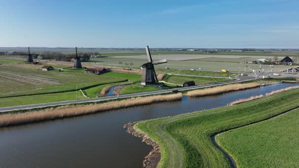 Historic Dutch Windmills in a Farm and Grass Field Landscape in The Netherlands Holland