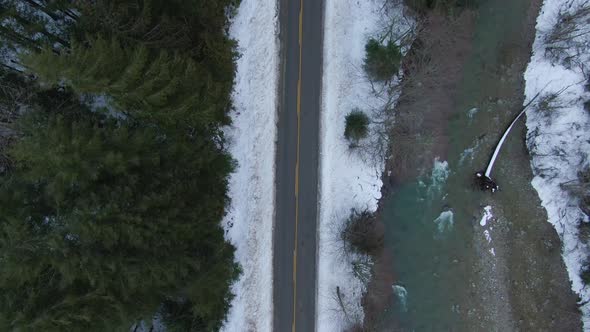 Aerial View From Above of Road By Fresh Water Flowing Down a River Creek