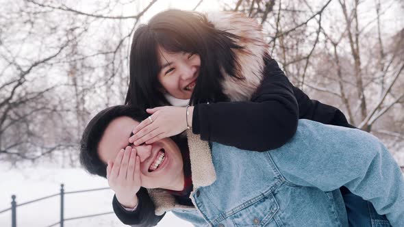 Happy Asian Couple Having Fun Outside on Valentines Day