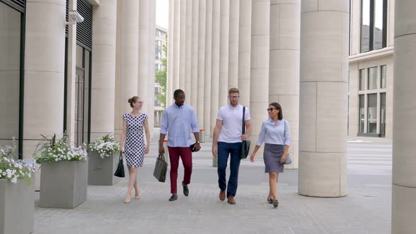 Multiethnic Business Coworkers Walking Outside Modern Business Center and Talking