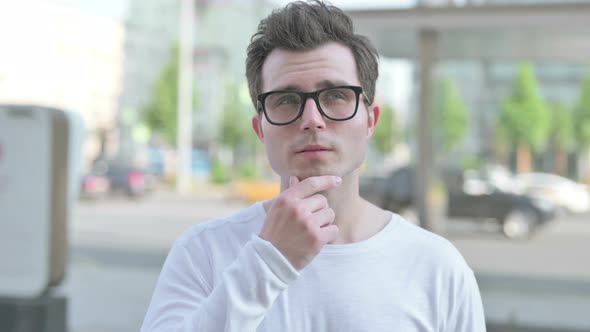 Portrait of Pensive Young Man Thinking Outdoor