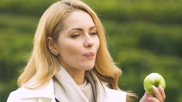 Attractive Pregnant Lady Eating Fresh Apple, Healthy Nutrition for Mother-To-Be