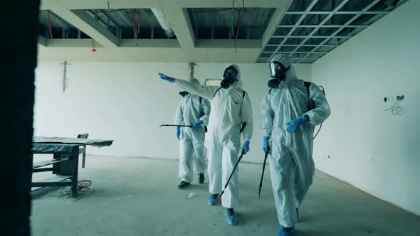 Workers Check Unfinished Building Before Disinfecting It