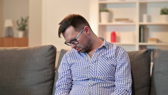 Sleepy Young Man Taking Nap at Home 