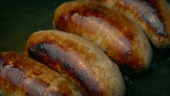 Pork Sausages Frying Closeup