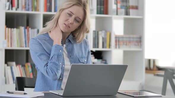 Tired Woman with Neck Pain Working on Laptop