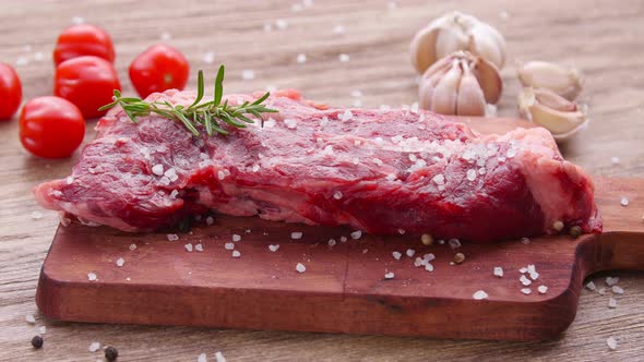 Raw Fresh Meat Steak with Herbs and Spices on Rustic Background