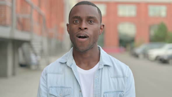 Outdoor Portrait of African Man Shaking Head As Yes Sign Approval