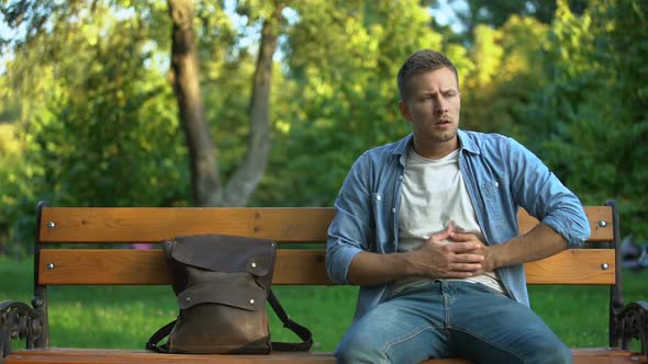 Man Relaxing on Bench, Suddenly Feeling Strong Stomach Ache, Gastritis Problem