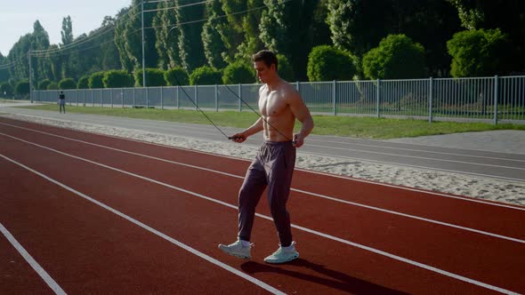 Athletic Man Jumping Rope Outdoors