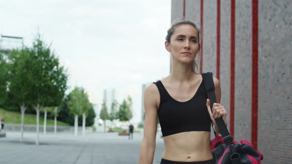 Video of woman walking in a training outfit in the city. Shot with RED helium camera in 8K. 