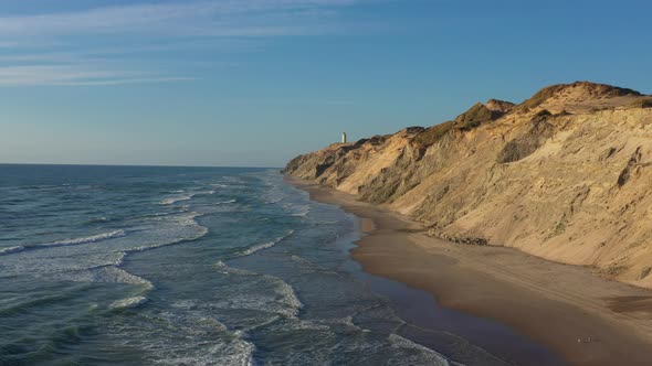 Drone Flight Over Coastline Towards Rubjerg Knude Lighthouse Hjorring Denmark