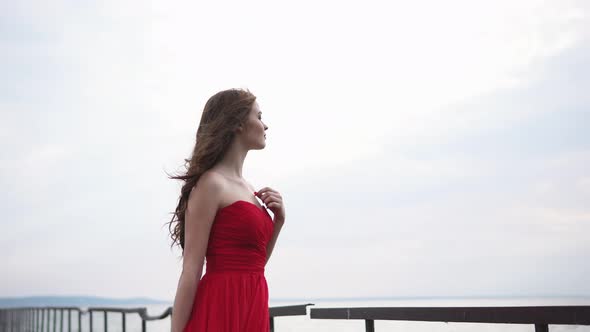 Lovely Woman is Enjoying the View of the Shore