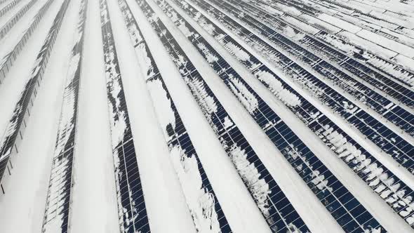 AERIAL: Solar Panel Field with Snow on Panels. Alternative Energy Sources in the Nordic Countries.