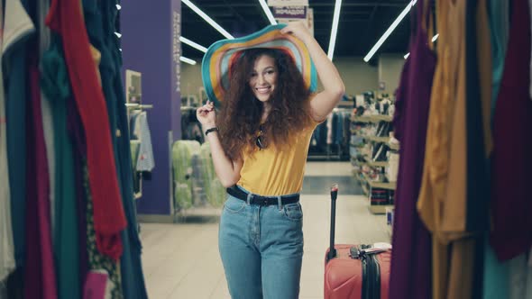 Young Lady Is Smiling and Walking Along the Shop