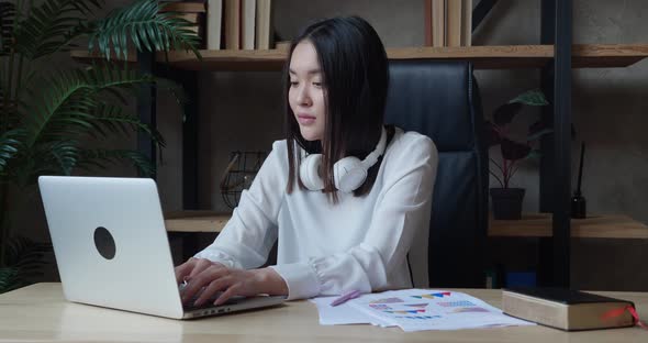 Young Asian Business Woman Worker Relax Sit at Office Desk Finished Laptop Computer Work Put Hands