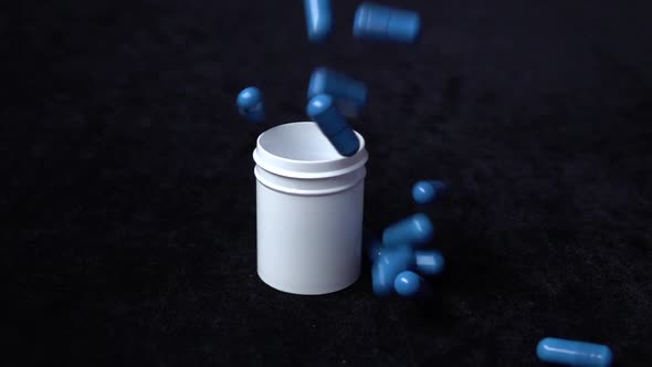 Medicine Blue Pills Falling Down on Black, Slow Motion