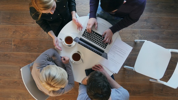 Group of business people working at the desk and leaving