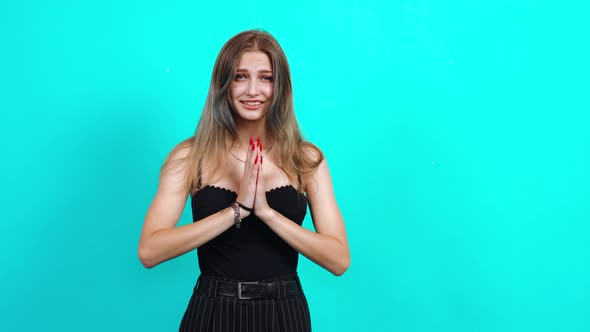 Shy and Harmless Woman Prays Holding Hands Together