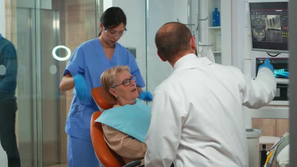 Nurse Putting Dental Bib to Old Woman