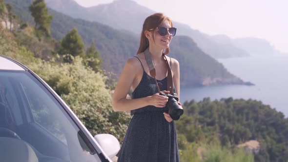 Young Redhaired Woman Traveler Walks and Has a Good Time on the Rocky Island of Mallorca