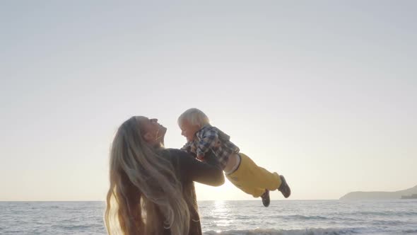 Mom and Son Having Fun on the Beach