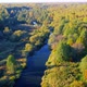 Aerial View of the River Among Forest in the Wild During Fall Season at Sunset - VideoHive Item for Sale