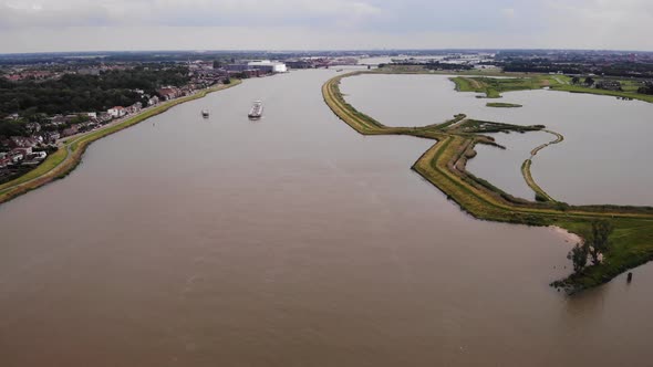 High Aerial View Of Shipping Vessel On River Noord. Pedestal Down, Dolly Forward