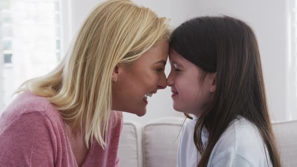 Mother embracing her daughter at home