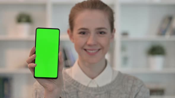 Portrait of Young Woman Showing Smartphone with Chroma Key Screen 