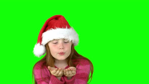 Festive girl blowing in slow motion