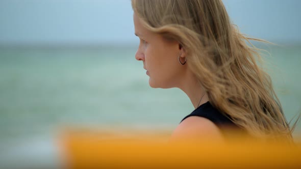 Woman with hair waving in the wind Portrait against the sea