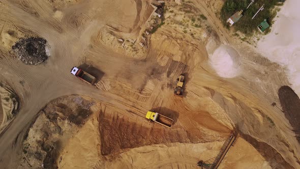 Yellow Excavator Loads Sand Into the Dumper