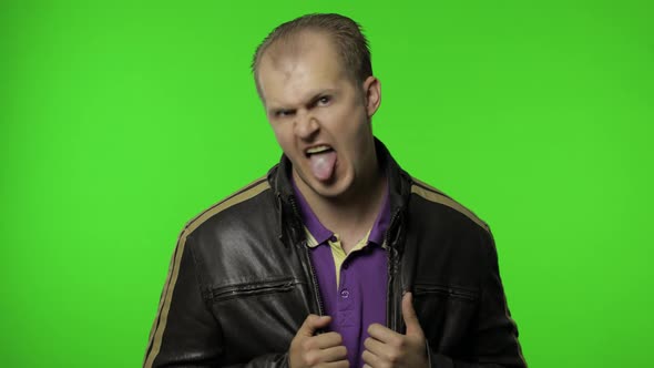 Aggressive Rocker Man in Brown Leather Jacket Showing Tongue and Looking with Crazy Expression