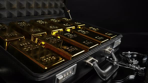 Handcuffed Suitcase with Pure Gold Bars