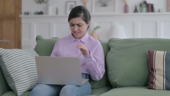 Indian Woman Feeling Angry while Working on Laptop on Sofa