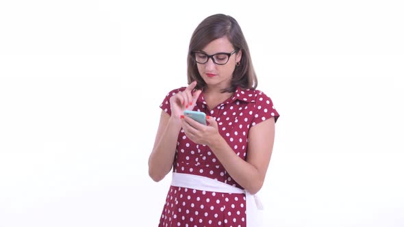 Happy Beautiful Woman with Eyeglasses Thinking While Using Phone